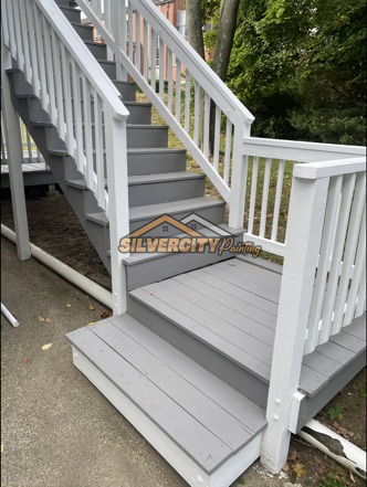 After painting — side view of refinished deck stairs, landing and railings
