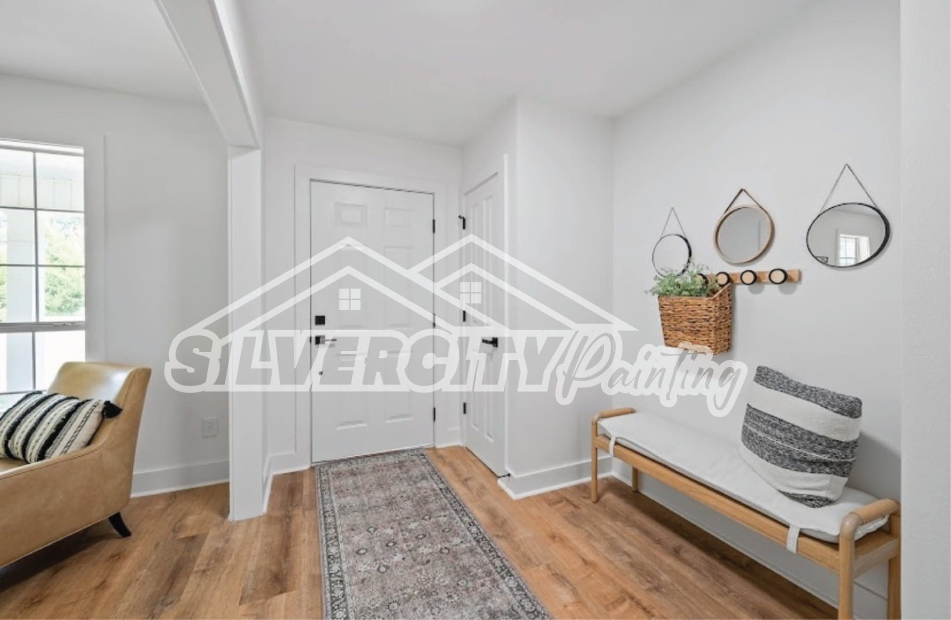 Bright white entryway and hallway with freshly painted doors and baseboards