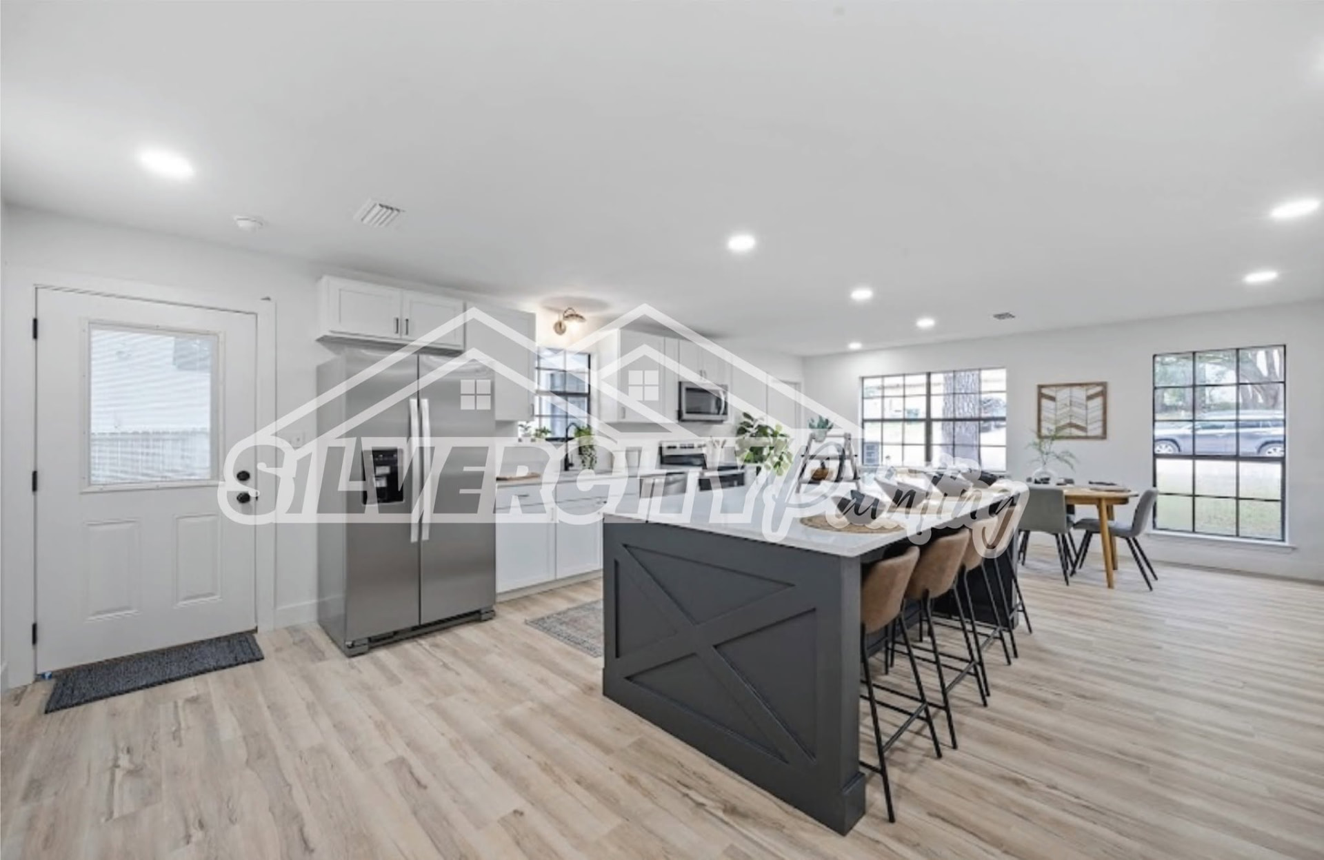 Freshly painted white kitchen cabinets and charcoal island in a Taunton, MA home