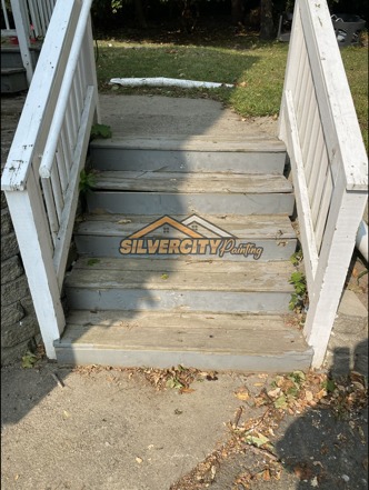 Before painting — worn exterior stair treads and weathered white railings