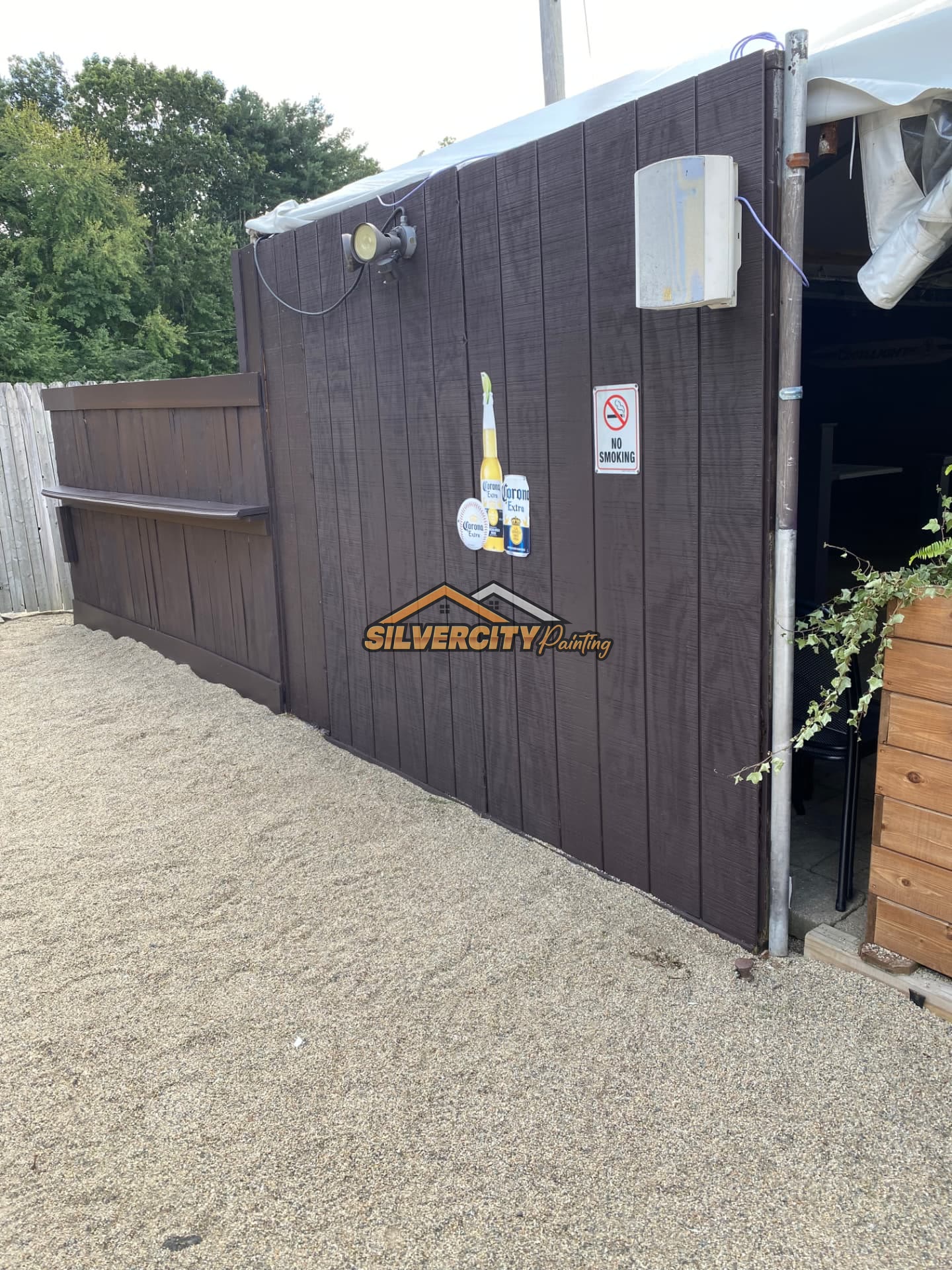 After painting — commercial dumpster enclosure fence coated in rich solid brown in Taunton, MA